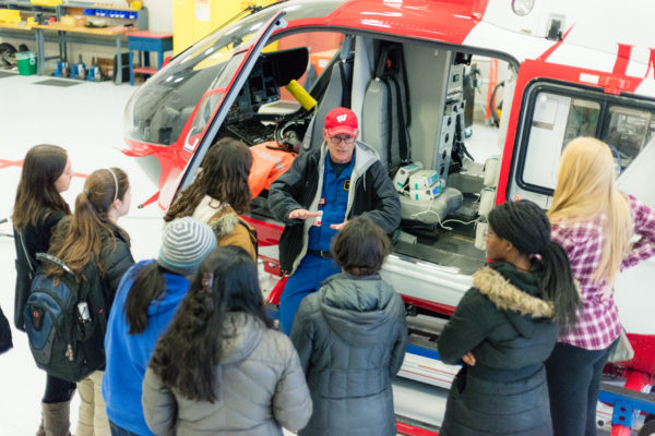 BioHouse students listening to a member of Med Flight give a tour of the Med Flight helicopter