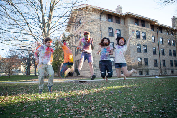 ILC members jumping in the air at their Holi Festival