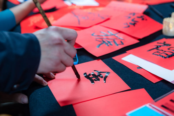 ILC resident painting Chinese characters in preparation Chinese New Year