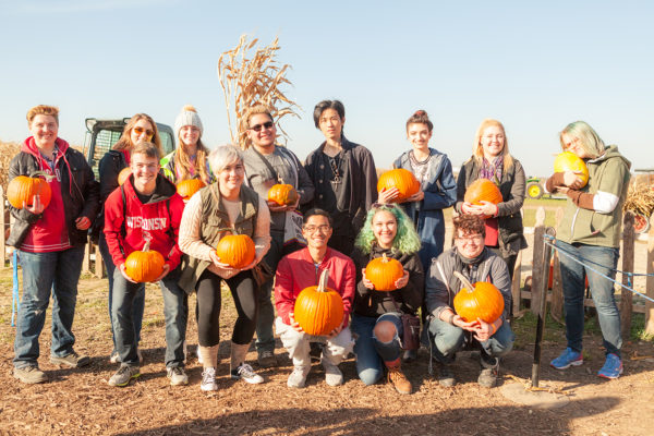 Open House residents pose with their freshly picked pumpkins at an outside orchard