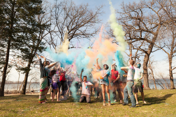 ILC members toss colored powder in the air as part of a Holi Festival