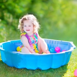 Toddler playing in kiddie pool