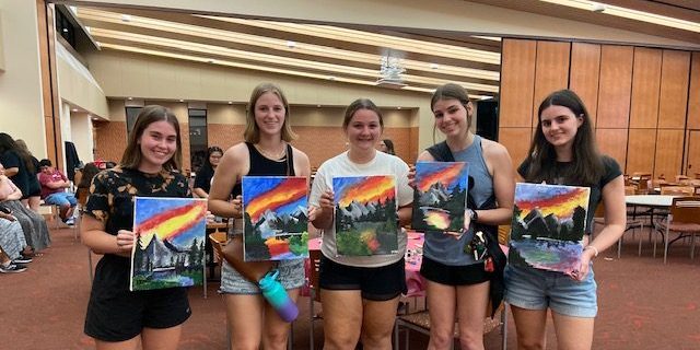 Students attending a Wisconsin Late Night Bob Ross Paint Night Event
