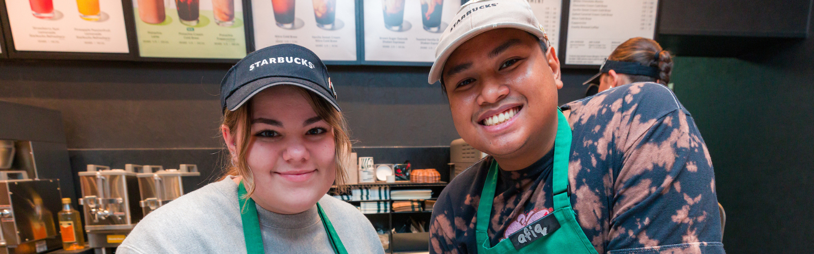Student Starbucks workers smiling