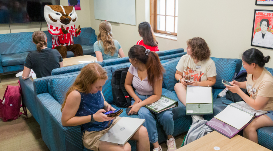 students and Bucky in lounge area