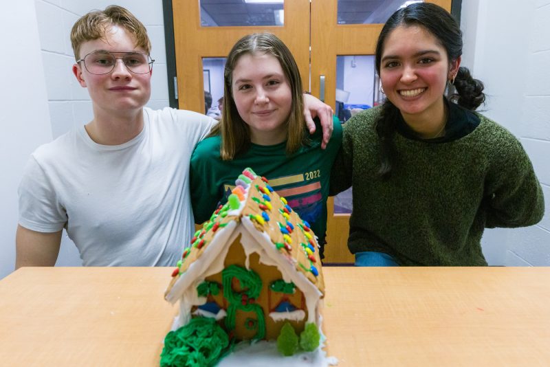 Biohouse students pose with completed gingerbread house
