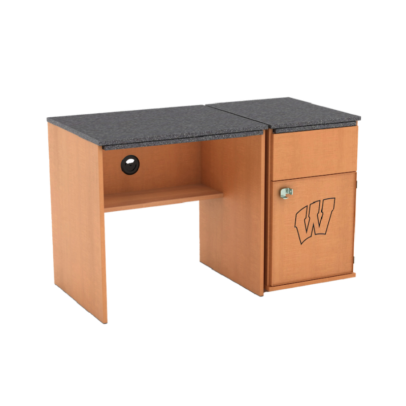 A medium-colored wood desk with a dark gray top and an attached pedestal with a drawer, a lockable cabinet, and the Wisconsin "Motion W"
