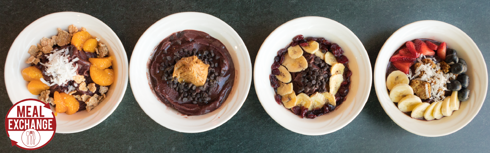four acai bowls lined up