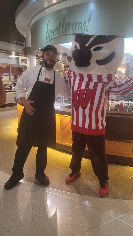 Badger Welcome Dinner - Bucky posing with staff member