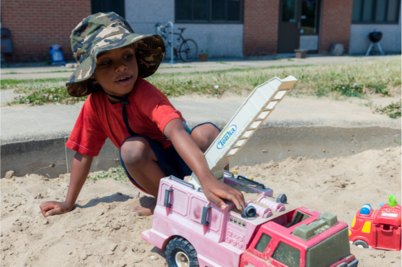 Child plying in one of the sandboxes near the Eagle Heights Community Center.